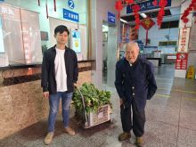 驾驶员李泽东帮助老人搬运菜下车