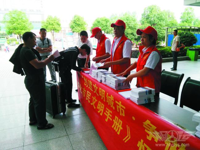 1468223763987226.jpg 志愿者给旅客免费发放《怀化市文明手册》.jpg